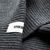 Close-up of Stiksen woven logo label on Dark Grey Beanie 01 merino wool beanie