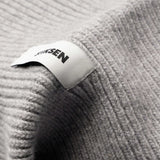 Close-up of Stiksen woven logo label on Light Grey Beanie 01 merino wool beanie