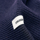 Close-up of Stiksen woven logo label on Navy Beanie 01 merino wool beanie