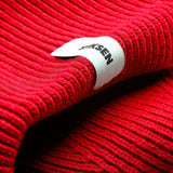 Close-up of Stiksen woven logo label on Red Beanie 01 merino wool beanie