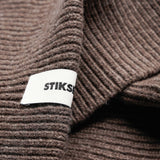 Close-up of Stiksen woven logo label on Taupe Beanie 01 merino wool beanie