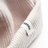 Close-up of Stiksen woven logo label on White Beanie 01 merino wool beanie