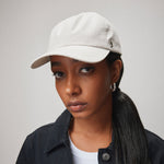 Stiksen 105 Ventile Stone dad cap worn by female model in soft indoor lighting