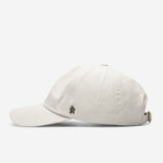 White Stone Ventile dad cap side view with curved brim and metal logo detail