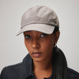 Stiksen 105 Ventile Taupe dad cap worn by female model in soft indoor lighting