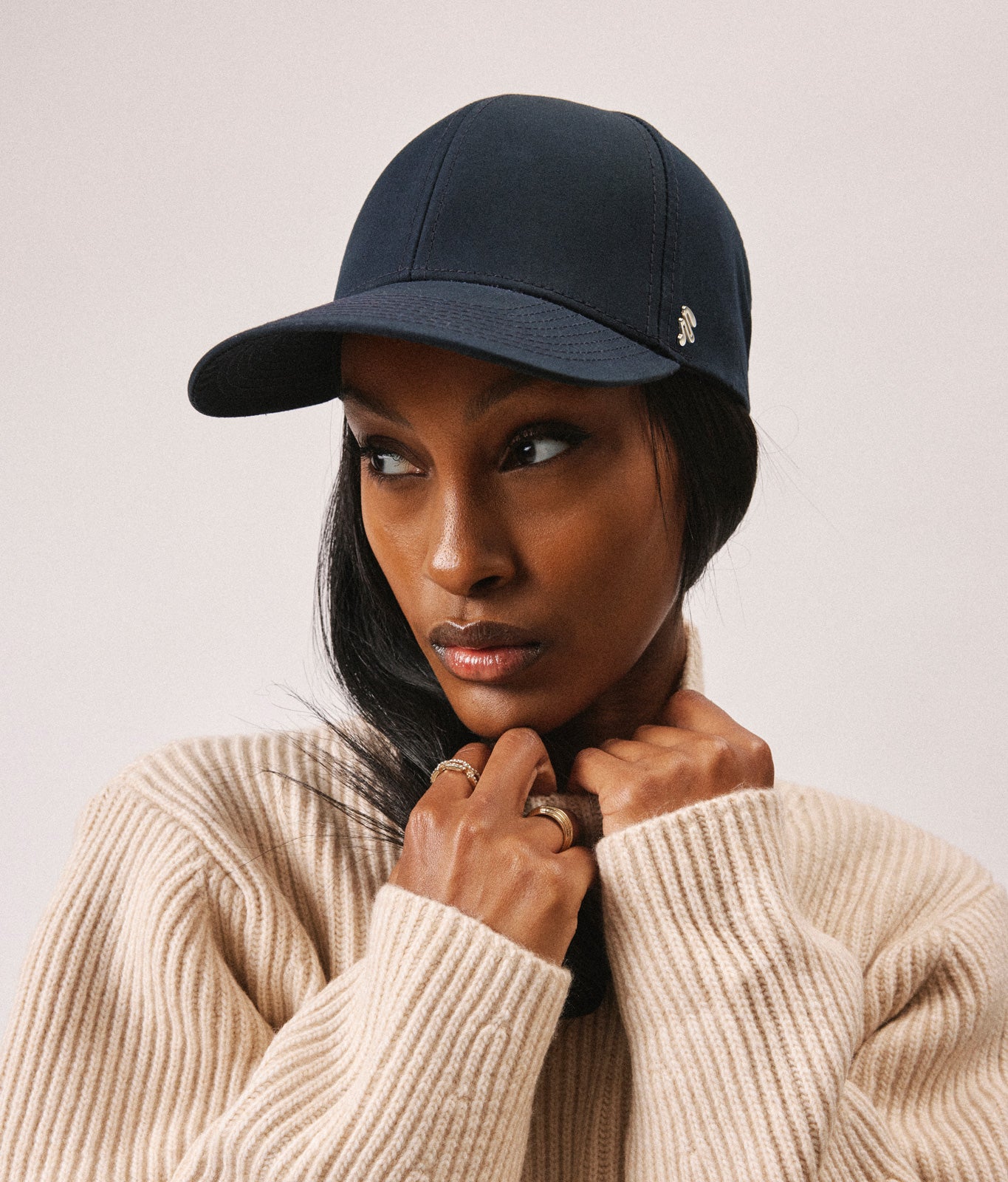 Stiksen 107 Ventile Midnight Blue baseball cap worn by female model in warm indoor lighting
