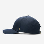 Midnight blue Ventile baseball cap side view with curved brim and metal logo detail