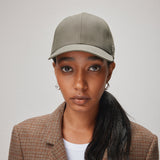 Stiksen 107 Ventile Moss Green baseball cap worn by female model in soft indoor lighting