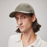 Stiksen 107 Ventile Moss Green baseball cap worn by model in soft indoor lighting