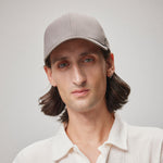 Stiksen 107 Ventile Taupe baseball cap worn by male model in soft indoor lighting