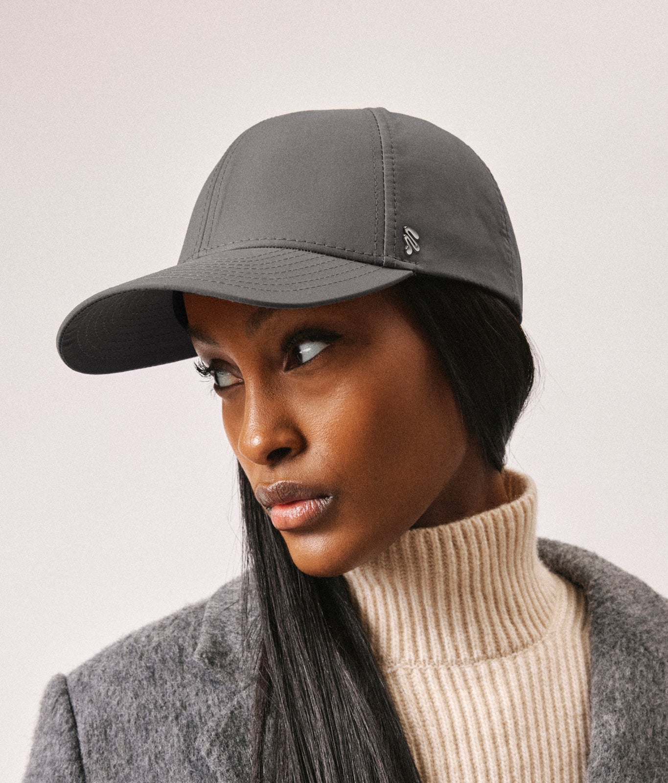 Stiksen 107 Ventile Taupe baseball cap worn by female model in soft indoor lighting