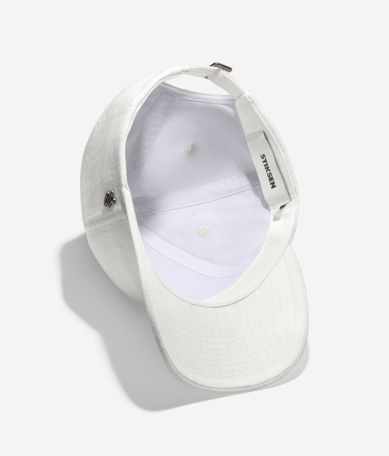 White linen baseball cap inside view showing interior cotton lining and adjustable strap